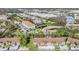 Aerial view of community apartment complex with a pond, parking, and lush landscaping at 2549 Royal Pines Cir # 16H, Clearwater, FL 33763