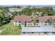 Aerial view showcasing condo layout, ample green space, and a covered parking area at 2549 Royal Pines Cir # 16H, Clearwater, FL 33763