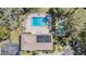 Overhead view of pool, tennis court, and clubhouse with solar panels in a beautifully maintained community at 2549 Royal Pines Cir # 16H, Clearwater, FL 33763