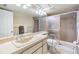 Neutral bathroom with a sliding glass shower door, a large mirror, and ample counter space at 2549 Royal Pines Cir # 16H, Clearwater, FL 33763