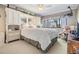 Bright bedroom featuring a plush bed, built-in storage, and a serene view from the large window at 2549 Royal Pines Cir # 16H, Clearwater, FL 33763