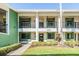 Inviting two-story condo with a lush green lawn and charming balconies, offering a warm, welcoming curb appeal at 2549 Royal Pines Cir # 16H, Clearwater, FL 33763