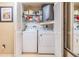 Laundry area featuring a washer and dryer inside a closet with louvered doors at 2549 Royal Pines Cir # 16H, Clearwater, FL 33763