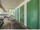 Row of green storage units under a covered parking area, accessible by nearby vehicles at 2549 Royal Pines Cir # 16H, Clearwater, FL 33763