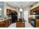 Well-lit kitchen features granite counters, wood cabinets, modern appliances and an island at 2966 Eagle Estates W Cir, Clearwater, FL 33761