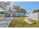 Quaint backyard features a lawn, privacy fence, concrete patio, seating area, and generator at 3127 W Lambright St # A, Tampa, FL 33614