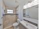 Updated bathroom featuring a tiled walk-in shower and modern vanity at 3127 W Lambright St # A, Tampa, FL 33614