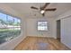 Bedroom features wood-look floors, a ceiling fan with light, and closet at 3127 W Lambright St # A, Tampa, FL 33614