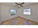 Bright bedroom features wood-look floors, neutral walls, and a ceiling fan with light at 3127 W Lambright St # A, Tampa, FL 33614