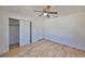 Bedroom features wood-look floors, a ceiling fan with light, and closet at 3127 W Lambright St # A, Tampa, FL 33614