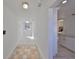Bright hallway with tile flooring and access to the kitchen and other areas of the home at 3127 W Lambright St # A, Tampa, FL 33614