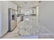 Bright kitchen features white cabinets, stainless appliances, and a granite island at 3127 W Lambright St # A, Tampa, FL 33614