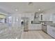 Bright kitchen features white cabinets, stainless appliances, and a granite island at 3127 W Lambright St # A, Tampa, FL 33614