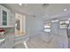 Bright kitchen with white cabinets, granite countertops, an island, and access to the backyard at 3127 W Lambright St # A, Tampa, FL 33614