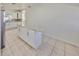 Bright kitchen featuring white cabinets, granite countertops, tile flooring, and an island at 3127 W Lambright St # A, Tampa, FL 33614