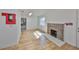 Neutral-toned living room area with wood floors and a brick fireplace at 3127 W Lambright St # A, Tampa, FL 33614