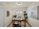 Home office with a wooden desk, comfortable chair, natural light, and minimalist decor at 3507 King George Ln, Seffner, FL 33584