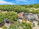 An aerial view of the property showcasing solar panels, mature landscaping, and nearby neighborhood streets at 3616 Cypress Meadows Rd, Tampa, FL 33624