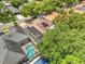 An aerial view of the property showing the screened-in pool, solar panels, and beautiful landscaping at 3616 Cypress Meadows Rd, Tampa, FL 33624