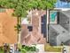 An aerial view of the property with a beautiful pool and a solar panel system on the roof at 3616 Cypress Meadows Rd, Tampa, FL 33624