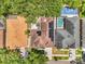 An aerial view of the property showing the screened-in pool, beautiful landscaping, and solar panels at 3616 Cypress Meadows Rd, Tampa, FL 33624