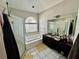 Bathroom featuring a soaking tub with tile surround, a glass shower, and double vanity sink at 3616 Cypress Meadows Rd, Tampa, FL 33624