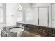 Bathroom vanity with a dark countertop, sink, and chrome faucet at 3616 Cypress Meadows Rd, Tampa, FL 33624