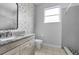 Bathroom featuring modern vanity with granite countertop and tiled shower at 3616 Cypress Meadows Rd, Tampa, FL 33624
