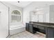 Bathroom featuring a shower, garden tub, and vanity with a dark countertop at 3616 Cypress Meadows Rd, Tampa, FL 33624