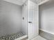 Stylish bathroom with gray subway tile in the shower and hexagonal shower floor at 3616 Cypress Meadows Rd, Tampa, FL 33624