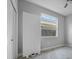 Bright bedroom featuring gray walls, carpet, window and closet with door removed at 3616 Cypress Meadows Rd, Tampa, FL 33624