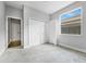 Well-lit bedroom features a large window, plush carpet and a closet at 3616 Cypress Meadows Rd, Tampa, FL 33624