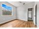 Bright bedroom features hardwood floors, white trim, ceiling fan and a large window offering natural light at 3616 Cypress Meadows Rd, Tampa, FL 33624