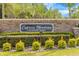 Community sign for Cypress Meadows showing stone details, landscaping, and deed restrictions at 3616 Cypress Meadows Rd, Tampa, FL 33624