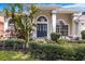 Inviting home featuring a beautifully landscaped front yard, lush plants and a welcoming entrance at 3616 Cypress Meadows Rd, Tampa, FL 33624