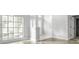 Light-filled foyer featuring large windows, columns, and a decorative front door at 3616 Cypress Meadows Rd, Tampa, FL 33624