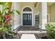 Stylish front entrance with decorative glass door, transom window, and tiled porch at 3616 Cypress Meadows Rd, Tampa, FL 33624