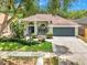 Charming one-story home with lush green lawn, mature trees, and a well-manicured front yard at 3616 Cypress Meadows Rd, Tampa, FL 33624