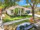 Beautiful one-story home with lush landscaping, healthy green lawn, and mature shade trees at 3616 Cypress Meadows Rd, Tampa, FL 33624