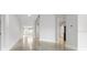 Hallway featuring polished concrete floors and views of the kitchen and front door at 3616 Cypress Meadows Rd, Tampa, FL 33624