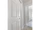 Hallway with white closet doors and a view of the primary bathroom at 3616 Cypress Meadows Rd, Tampa, FL 33624
