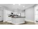 Modern kitchen with white cabinets, granite counters, stainless appliances and an island, creating a sleek and functional space at 3616 Cypress Meadows Rd, Tampa, FL 33624
