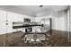 Spacious kitchen with a center island, stainless steel sink, granite countertops, and modern appliances for a functional design at 3616 Cypress Meadows Rd, Tampa, FL 33624