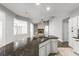 Kitchen featuring granite countertops and stainless steel sink, connecting to an open floor plan with ample natural light at 3616 Cypress Meadows Rd, Tampa, FL 33624
