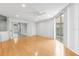 Bright and airy living room with open doorway and light wood floors at 3616 Cypress Meadows Rd, Tampa, FL 33624