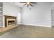 Spacious living room with a cozy fireplace and natural light, providing a comfortable and inviting atmosphere at 3616 Cypress Meadows Rd, Tampa, FL 33624