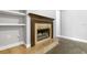 Living room showcases a cozy fireplace and decorative mantel, creating a warm and inviting atmosphere with adjacent shelving at 3616 Cypress Meadows Rd, Tampa, FL 33624