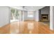 Spacious living room with hardwood floors, fireplace, and sliding glass doors to the backyard at 3616 Cypress Meadows Rd, Tampa, FL 33624