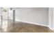 Spacious living room with polished concrete floors, white walls, and large windows at 3616 Cypress Meadows Rd, Tampa, FL 33624