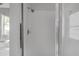 Neutral shower with glass door and tile floors at 3616 Cypress Meadows Rd, Tampa, FL 33624